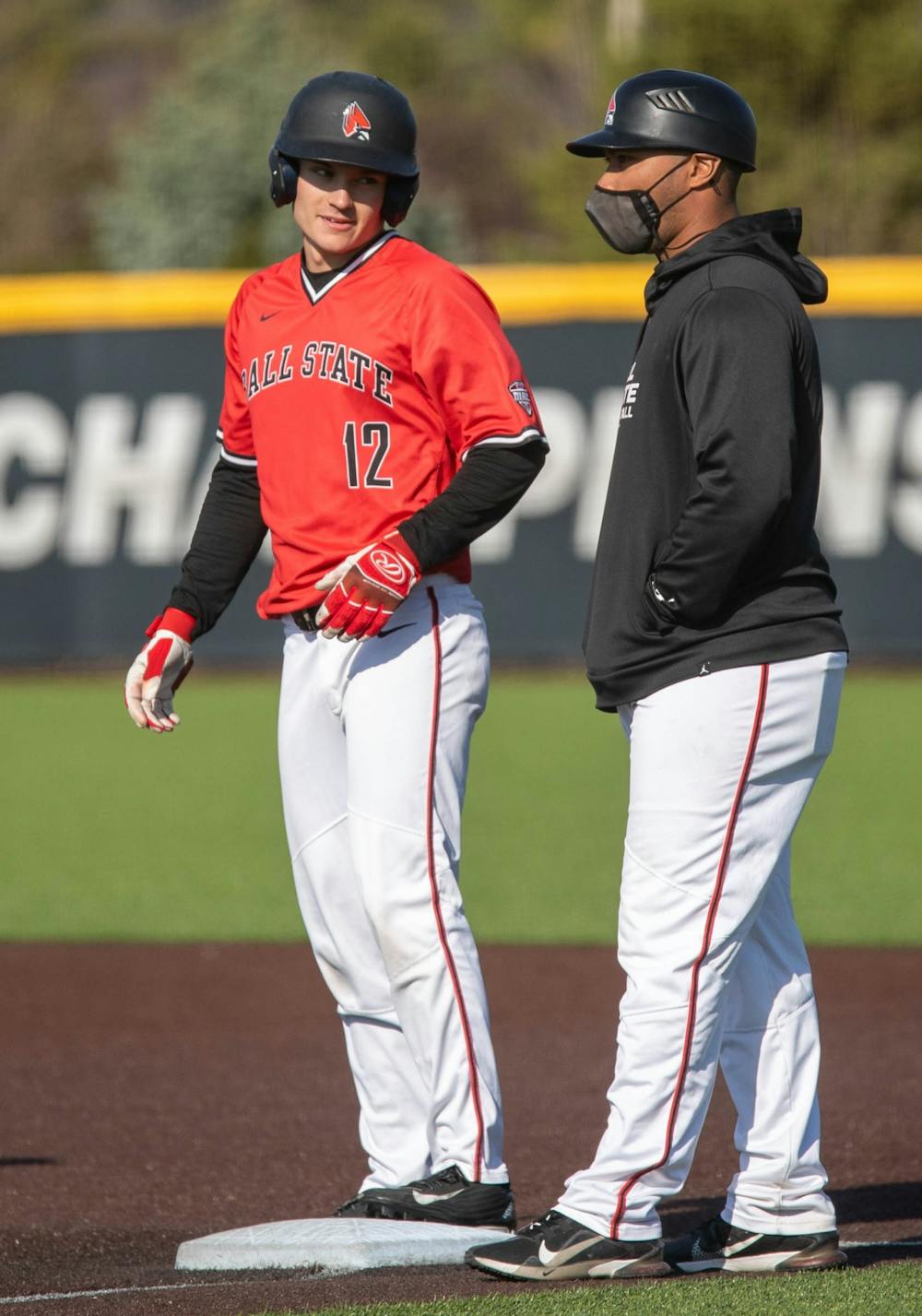<p>Sophomore outfielder Mack Murphy talks to assistant coach Blake Beemer after Murphy&#x27;s hit April 3, 2021, at Ball Diamond at First Merchants Ballpark Complex. The Cardinals won their second game of the day 16-10 against the Bulldogs. <strong>Jaden Whiteman, DN</strong></p>
