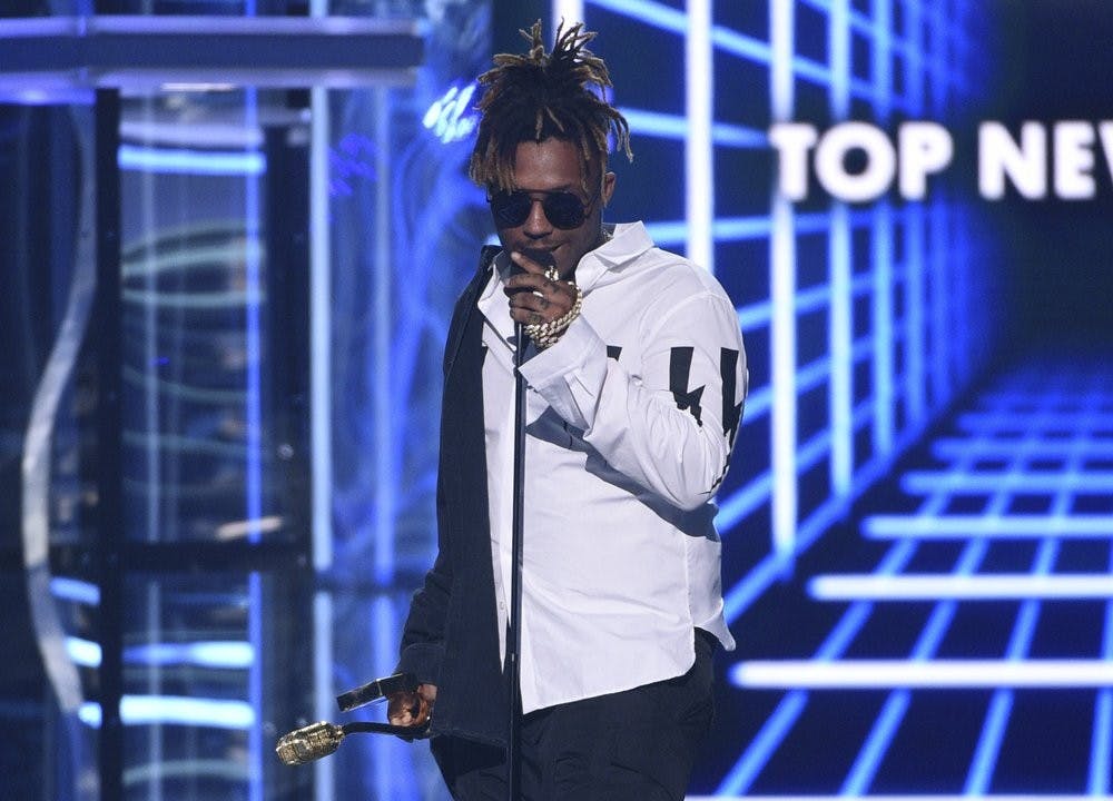 <p>In this May 1, 2019 file photo, Juice WRLD accepts the award for top new artist at the Billboard Music Awards at the MGM Grand Garden Arena in Las Vegas. Chicago police said they're conducting an investigation into the rapper's death after a medical emergency Dec. 8, 2019, at Chicago's Midway International Airport. <strong>(Photo by Chris Pizzello/Invision/AP File)</strong></p>