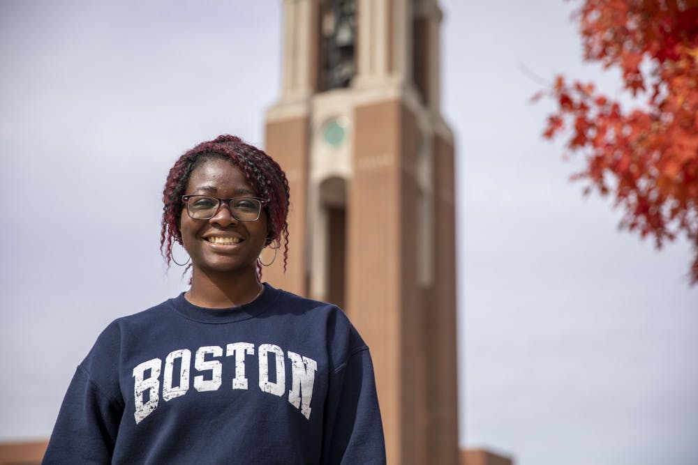 Emerging media and design graduate student Deborah Ojo poses in front of Shafer Tower Oct. 14, 2020, at University Green. Ojo works as a mentor for student-athletes and said she has had to work harder to make sure students get homework done in a virtual atmosphere. Jacob Musselman, DN