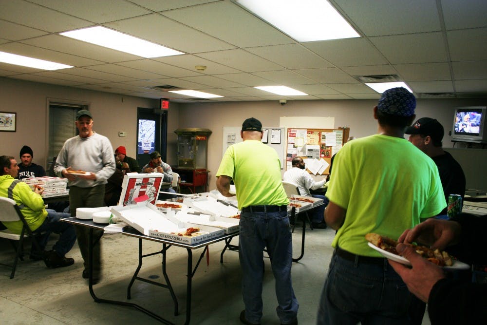 	Muncie mayor Dennis Tyler bough pizza and drinks for city sanitation workers Sunday.