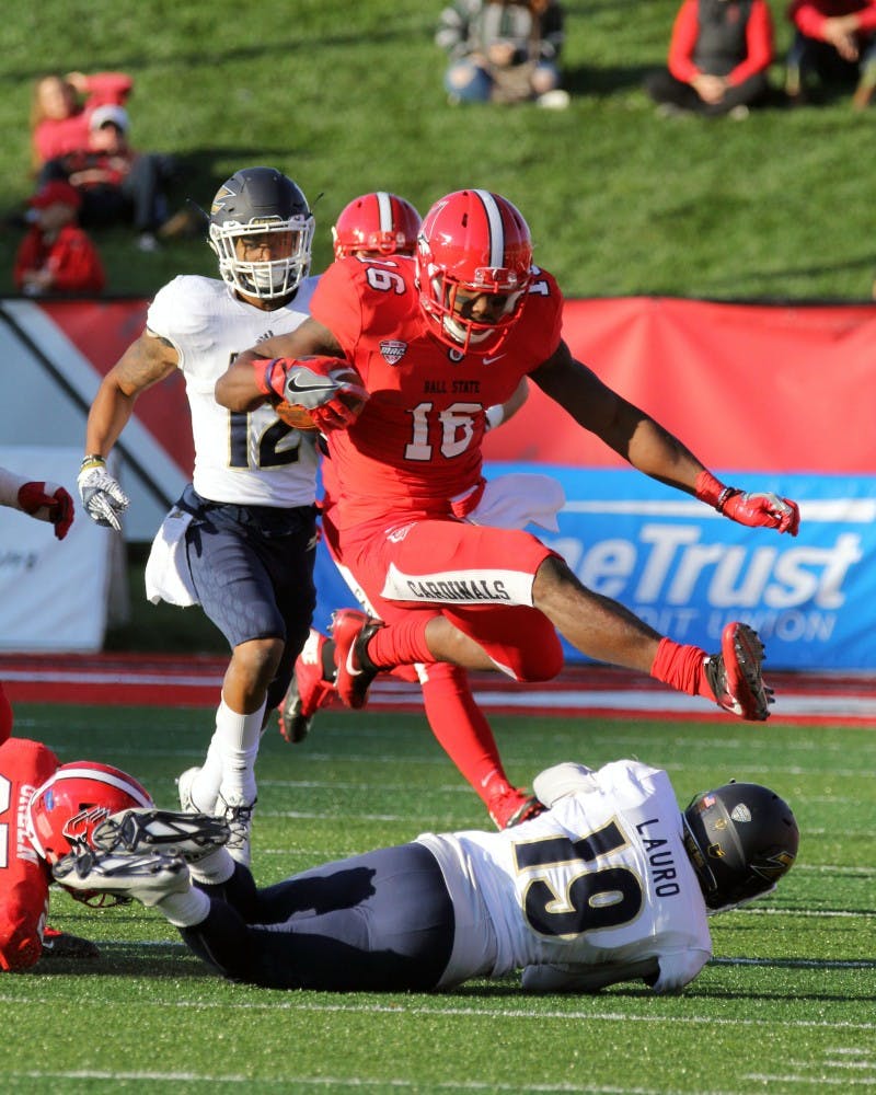 Wide receiver KeVonn Mabon hurdles a defender during the Cardinals’ game against Akron on Oct. 22 in Scheumann Stadium. Ball State lost 25 to 35. Paige Grider// DN