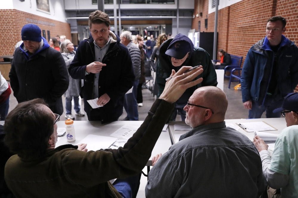 <p>Caucus goers check in at a caucus at Roosevelt High School, Monday, Feb. 3, 2020, in Des Moines, Iowa. <strong>(AP Photo/Andrew Harnik)</strong></p>