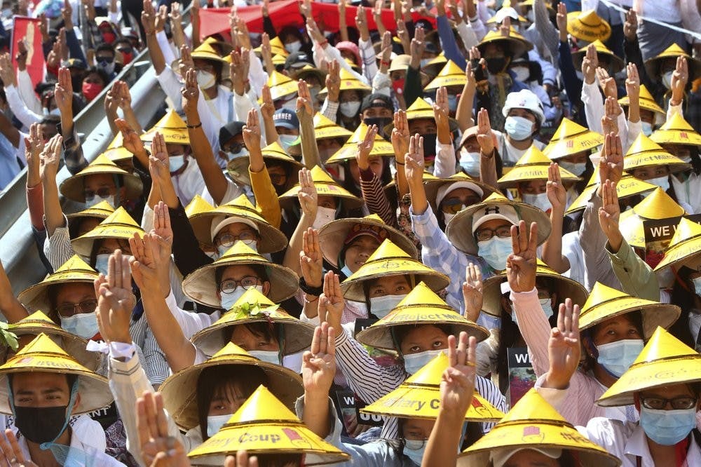 Anti-coup protesters flash the three-fingered salute during a rally near the Mandalay Railway Station in Mandalay, Myanmar Monday, Feb. 22, 2021. The protest movement, which seeks to restore power to the elected government of Aung San Suu Kyi and have her and other leaders released from detention, has embraced nonviolence. (AP Photo)