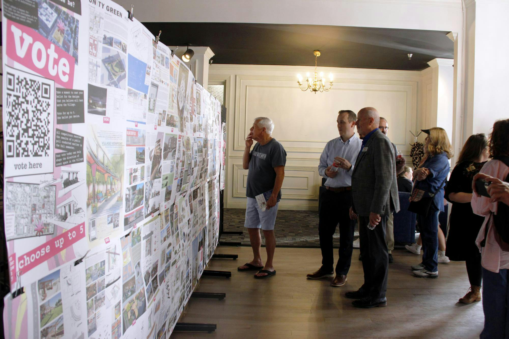 Attendees at ECAP's&nbsp;grand opening observing signage Oct. 2 inside the downtown Muncie, Ind. building. Katherine Hill, DN