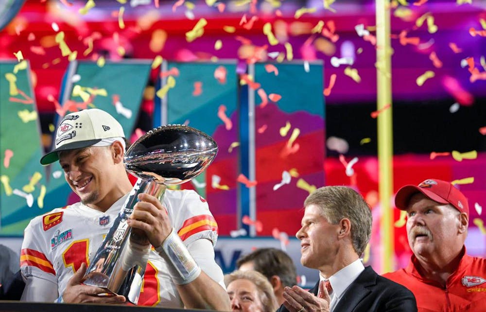 Kansas City Chiefs quarterback Patrick Mahomes (15) hoists the Lombardi Trophy after leading the Chiefs to a Super Bowl LVII victory, 38-35, over the Philadelphia Eagles on Sunday, Feb. 12, 2023, at State Farm Stadium in Glendale, Arizona. Chiefs Chairman &amp; CEO Clark Hunt and head coach Andy Reid look on. (Tammy Ljungblad/The Kansas City Star/TNS)