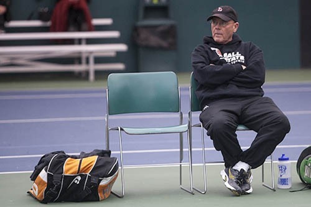 Head coach Bill Richards watched a match between his players and IPFW on Wednesday afternoon. Richards has been the head coach of the tennis team for 36 seasons. DN PHOTO JORDAN HUFFER