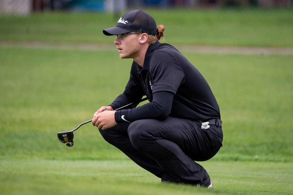 <p>Junior Sterling McIlravy squats down to look at the green Sept. 9, 2019. Mcllravy played two seasons of collegiate golf at two different junior colleges before coming to Ball State. <strong>Kirkwood Community College Athletics, Photo Provided</strong></p>