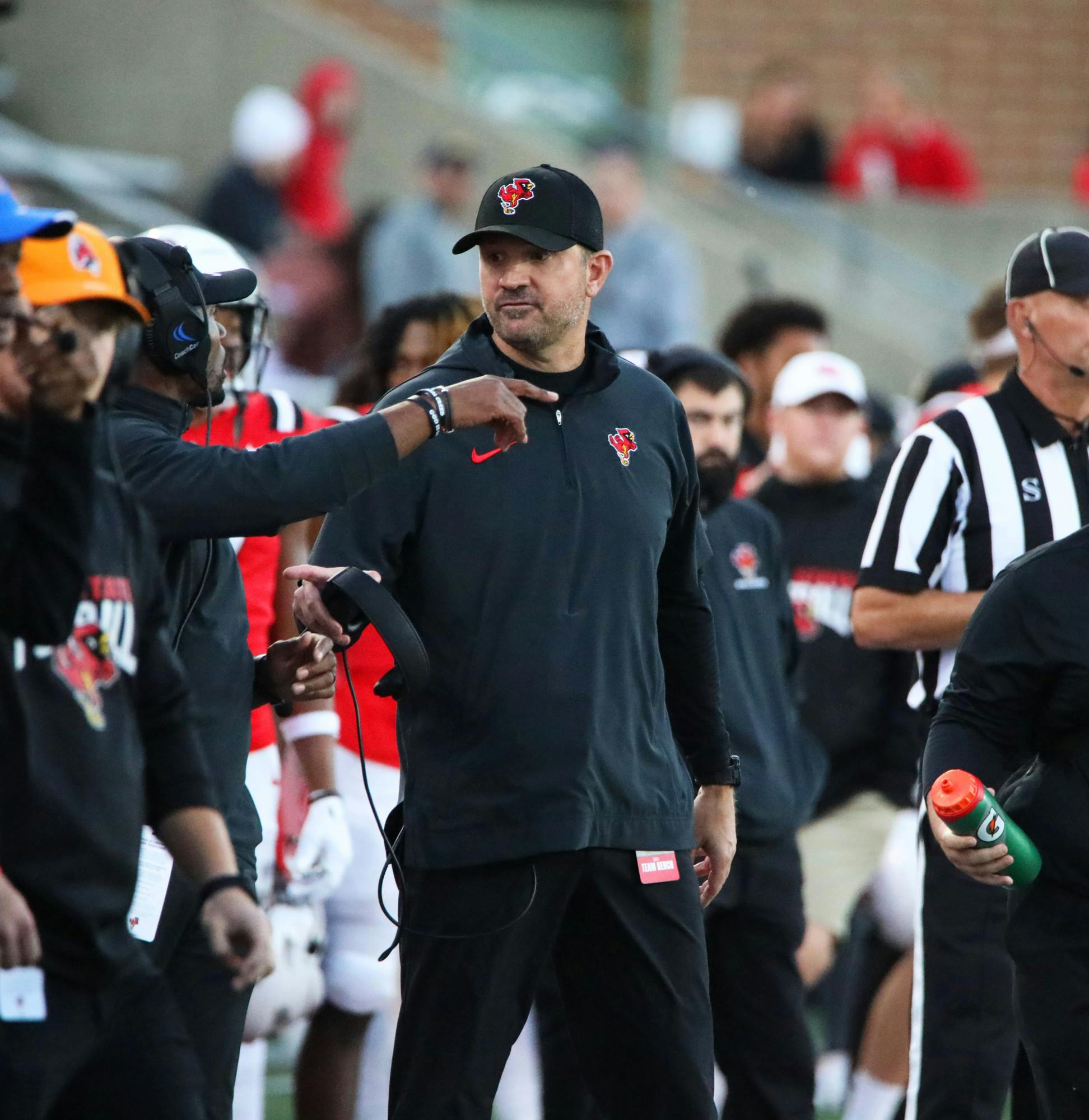 Head Coach Mike Neu talks with another coach during a game against Central Michigan Oct. 21 at Scheumann Stadium. Mya Cataline, DN