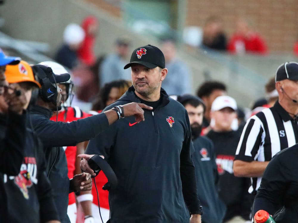 Head Coach Mike Neu talks with another coach during a game against Central Michigan Oct. 21 at Scheumann Stadium. Mya Cataline, DN