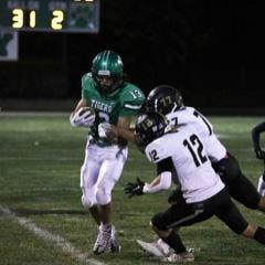 Yorktown senior Kolton Nanko takes prepares to take a hit against Mount Vernon on Oct. 14 at Tiger Stadium in Yorktown, Indiana. Brayden Goins, DN