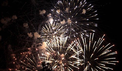 Blue, white and red fireworks are shot off in the sky above Muncie Central High School for last year’s annual firework show. The firework show in Downtown Muncie is one of several in the area.  DN FILE PHOTO RJ RICKER