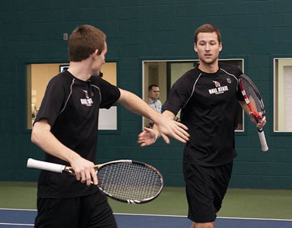 Sophomore Ray Leonard and senior Dalton Albertin congratulate each other after winning a doubles point in a match against Detroit Mercy on Jan. 25. The Cardinals have lost 10 of their last 15 doubles matches. DN FILE PHOTO BOBBY ELLIS