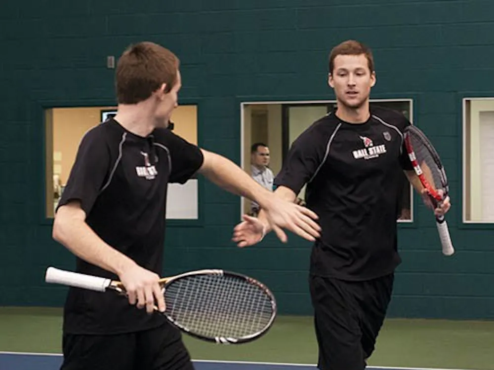 Sophomore Ray Leonard and senior Dalton Albertin congratulate each other after winning a doubles point in a match against Detroit Mercy on Jan. 25. The Cardinals have lost 10 of their last 15 doubles matches. DN FILE PHOTO BOBBY ELLIS