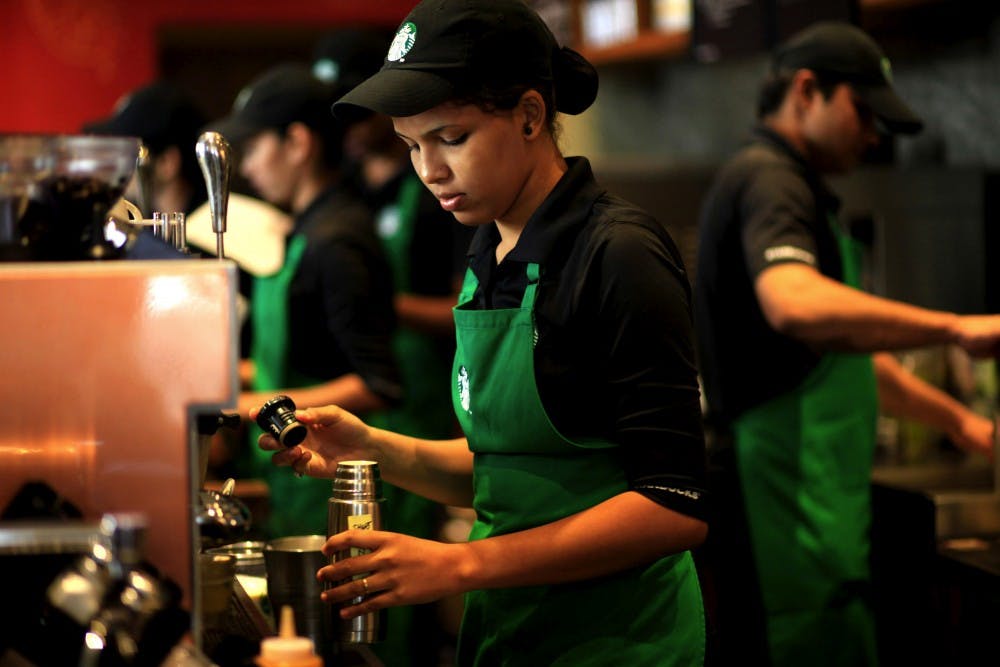 Employees work inside the Starbucks at the Taj Mahal Palace hotel in south Mumbai, India. (Erika Schultz/Seattle Times/MCT)