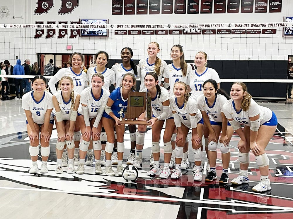 The Burris volleyball team poses with the sectional trophy Oct.14 after defeatiing Lapel in the sectional championship match. Zach Carter, DN.