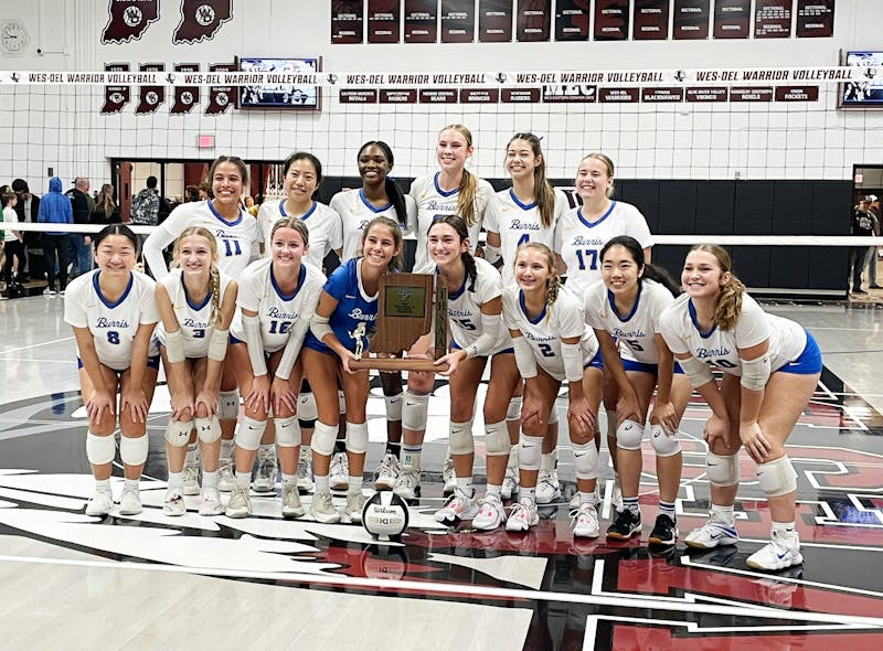 The Burris volleyball team poses with the sectional trophy Oct.14 after defeatiing Lapel in the sectional championship match. Zach Carter, DN.
