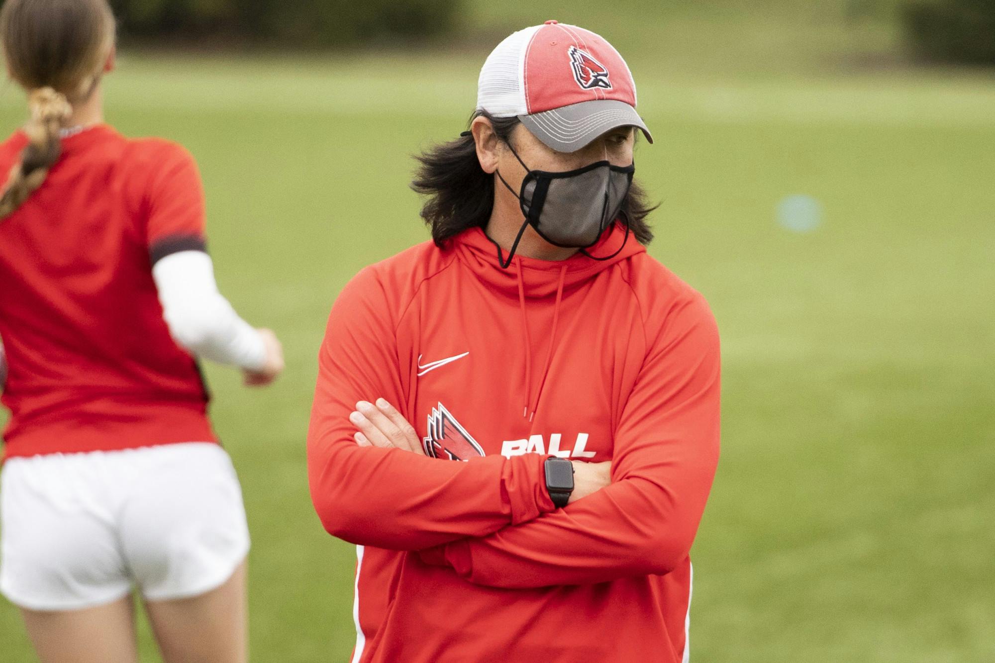 Cardinals head coach Josh Rife stands with the team during pregame practice March 26, 2021, at Briner Sports Complex. The Cardinals won 2-1 in overtime. Jacob Musselman, DN