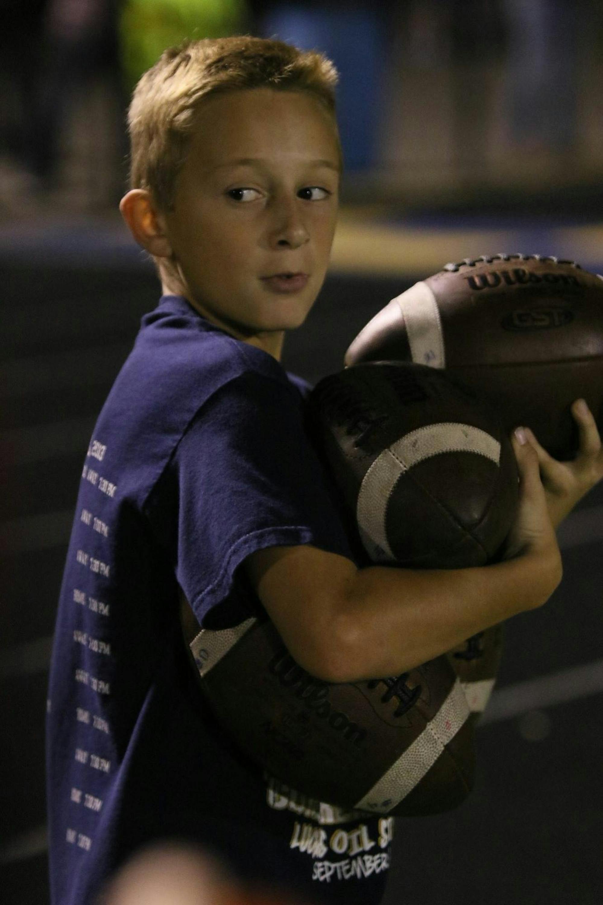 Young Bronson Edwards hold footballs at Delta High School football field Sept. 24, 2017. Bronson is currently the high school's quarterback. Kelli Edwards, Photo Provided