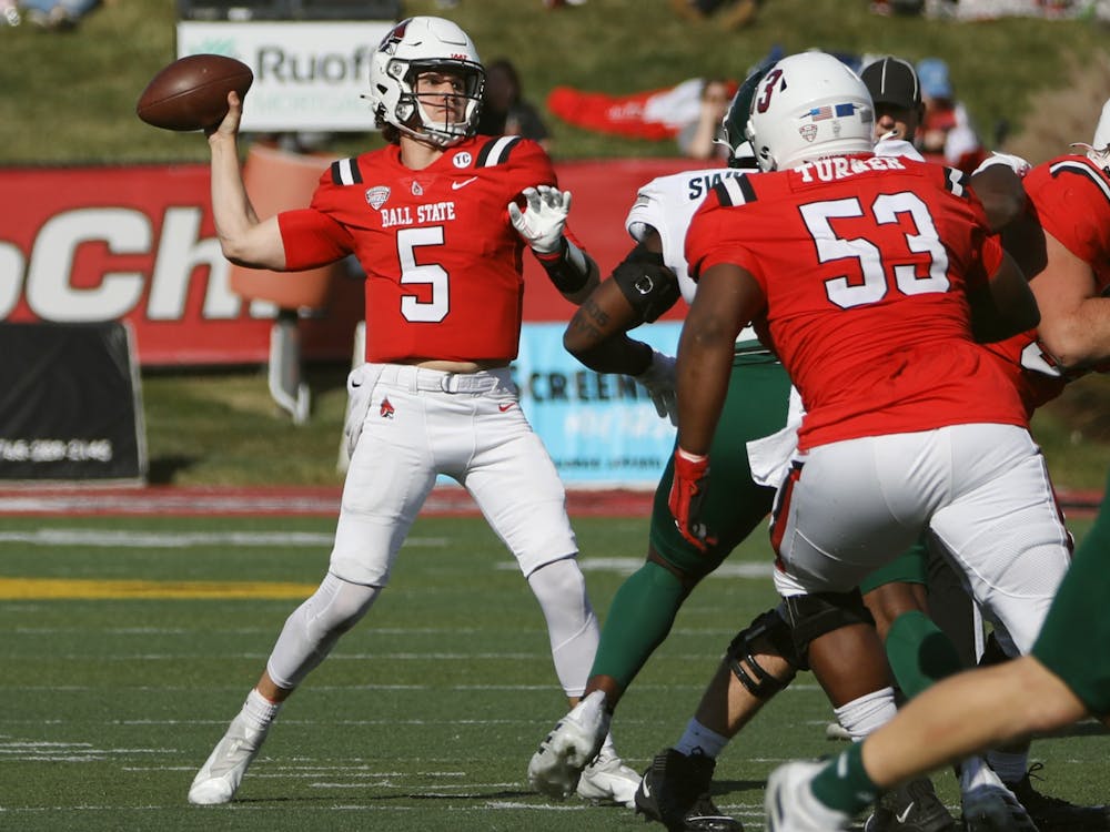 Redshirt junior quarterback John Paddock throws the football in Ball State's Homecoming Game against Eastern Michigan Oct. 22 at Scheumann Stadium. Paddock threw for 178 yards during the game. Amber Pietz, DN
