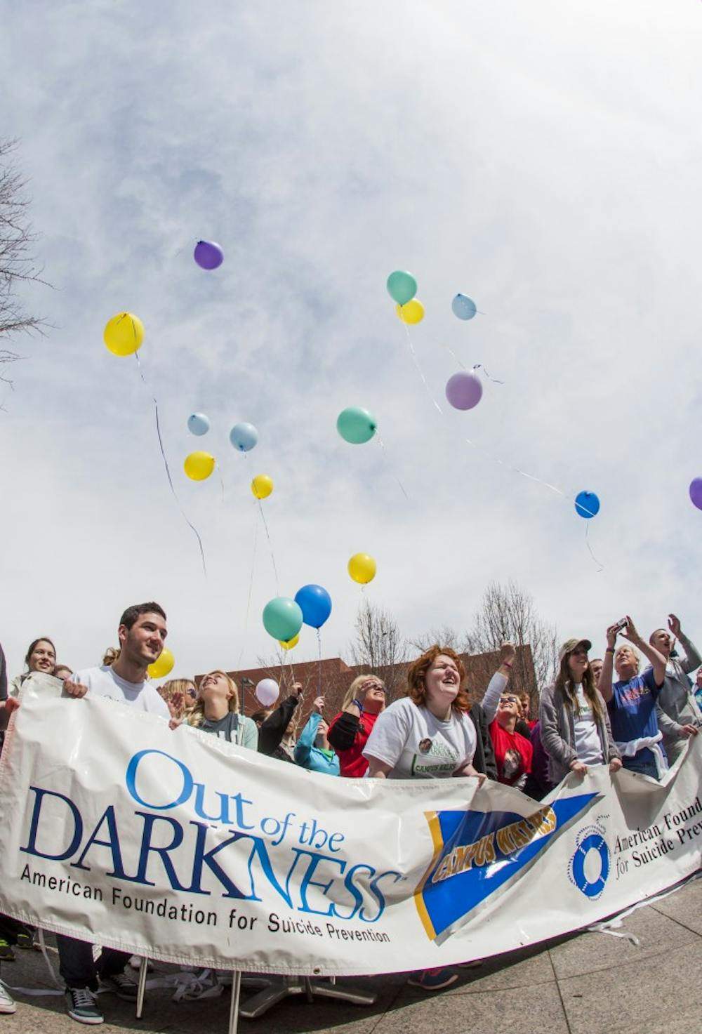 Participants in the Out of the Darkness Walk release balloons in memory of their loved ones at the conclusion of the event April 6. The event brought together people to bring attention to suicide and its prevention. DN PHOTO JONATHAN MIKSANEK
