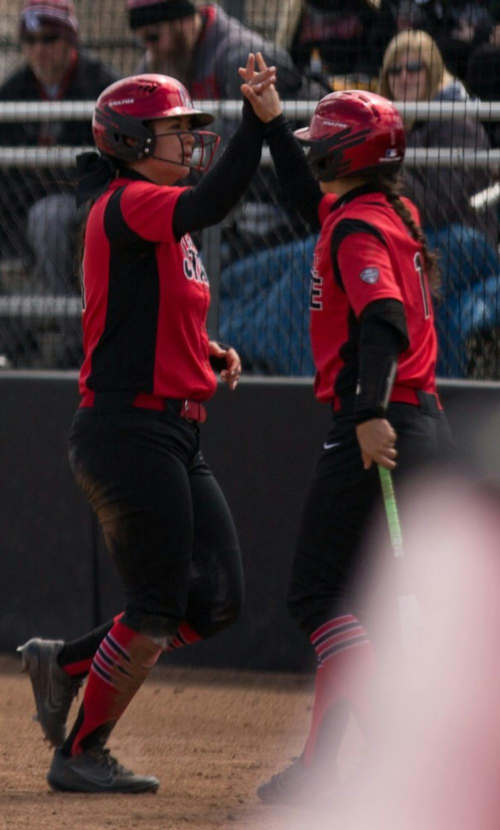 <p>Madison Lee high fives Madd Labrador after Lee scored a run in the second inning. Ball State lost to Kent State April 7 at the Softball Field at First Merchants Ballpark Complex. <strong>Eric Pritchett, DN</strong></p>