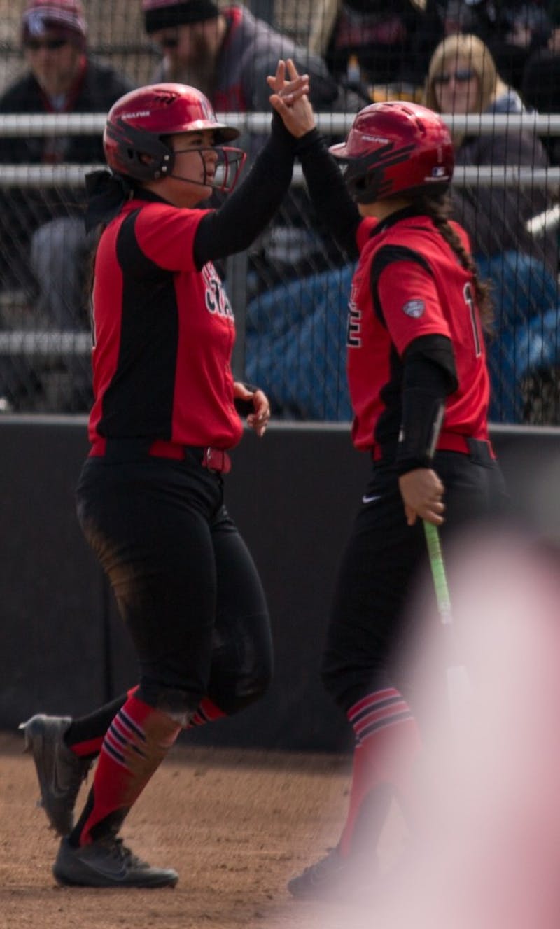 Madison Lee high fives Madd Labrador after Lee scored a run in the second inning. Ball State lost to Kent State April 7 at the Softball Field at First Merchants Ballpark Complex. Eric Pritchett, DN
