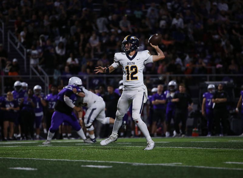 Delta senior quarterback Bronson Edwards throws Aug. 23 in a game against Muncie Central at Muncie Central High School. Edwards threw four touchdown passes in the win. Logan Connor, DN. 