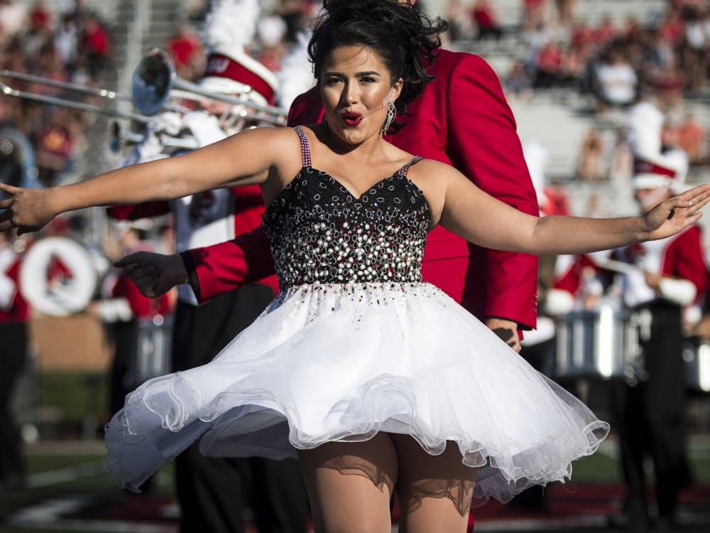A member of University Singers performs duirng the halftime show with the Pride of Mid-America marching band, Oct. 21 at Scheumann Stadium during the Homecoming football game against Central Michigan. Ball State lost to Central Michigan, 9-56. Grace Hollars, DN&nbsp;