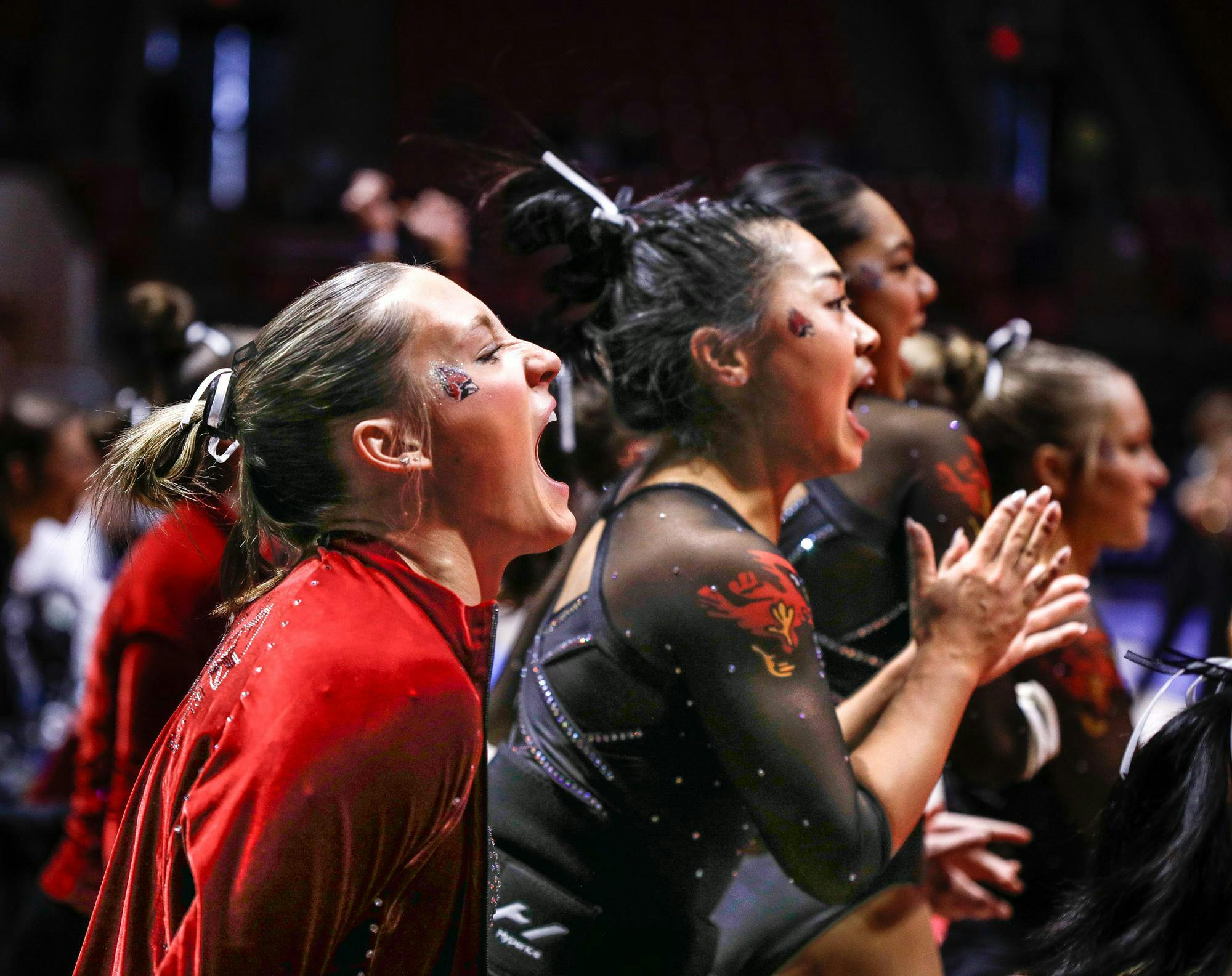 Ball State cheers for their fellow teammates as they perform floor March 23 at the Mid-American Championship at Worthen Arena. Ball State scored second in floor overall. Andrew Berger, DN