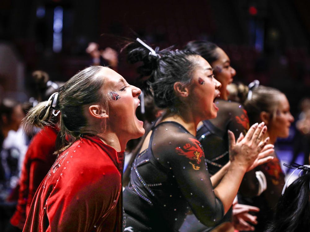 Ball State cheers for their fellow teammates as they perform floor March 23 at the Mid-American Championship at Worthen Arena. Ball State scored second in floor overall. Andrew Berger, DN