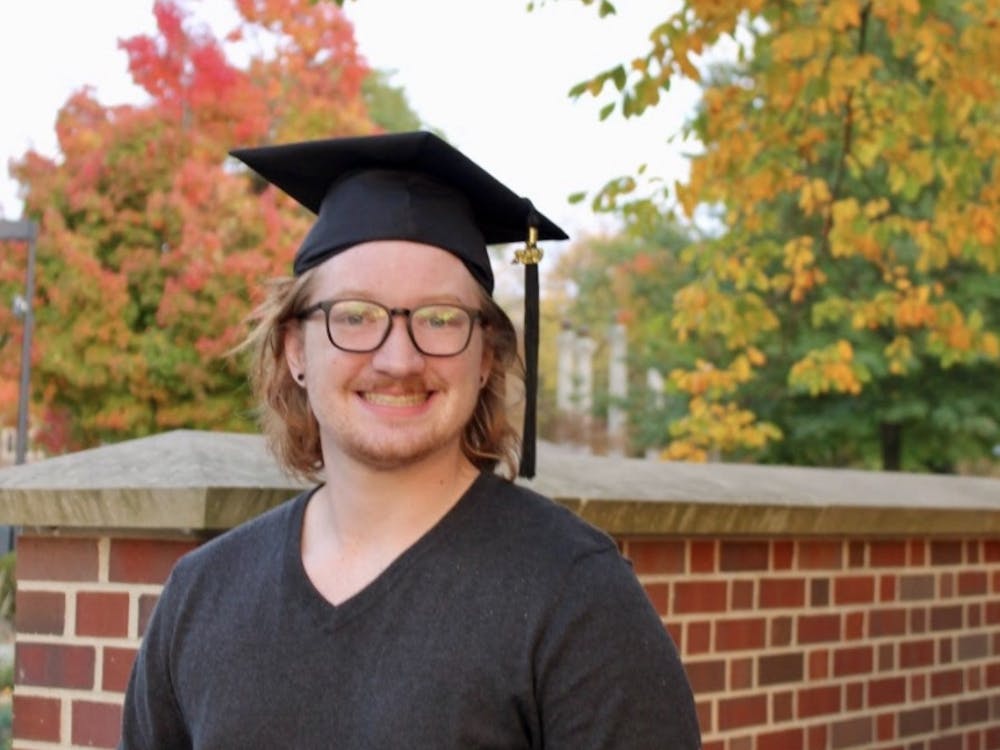 Hunter Wallace poses for a photo in his graduation cap. Wallace took a job at a software company after graduating in spring 2021, where he works from home. Hunter Wallace, Photo Provided