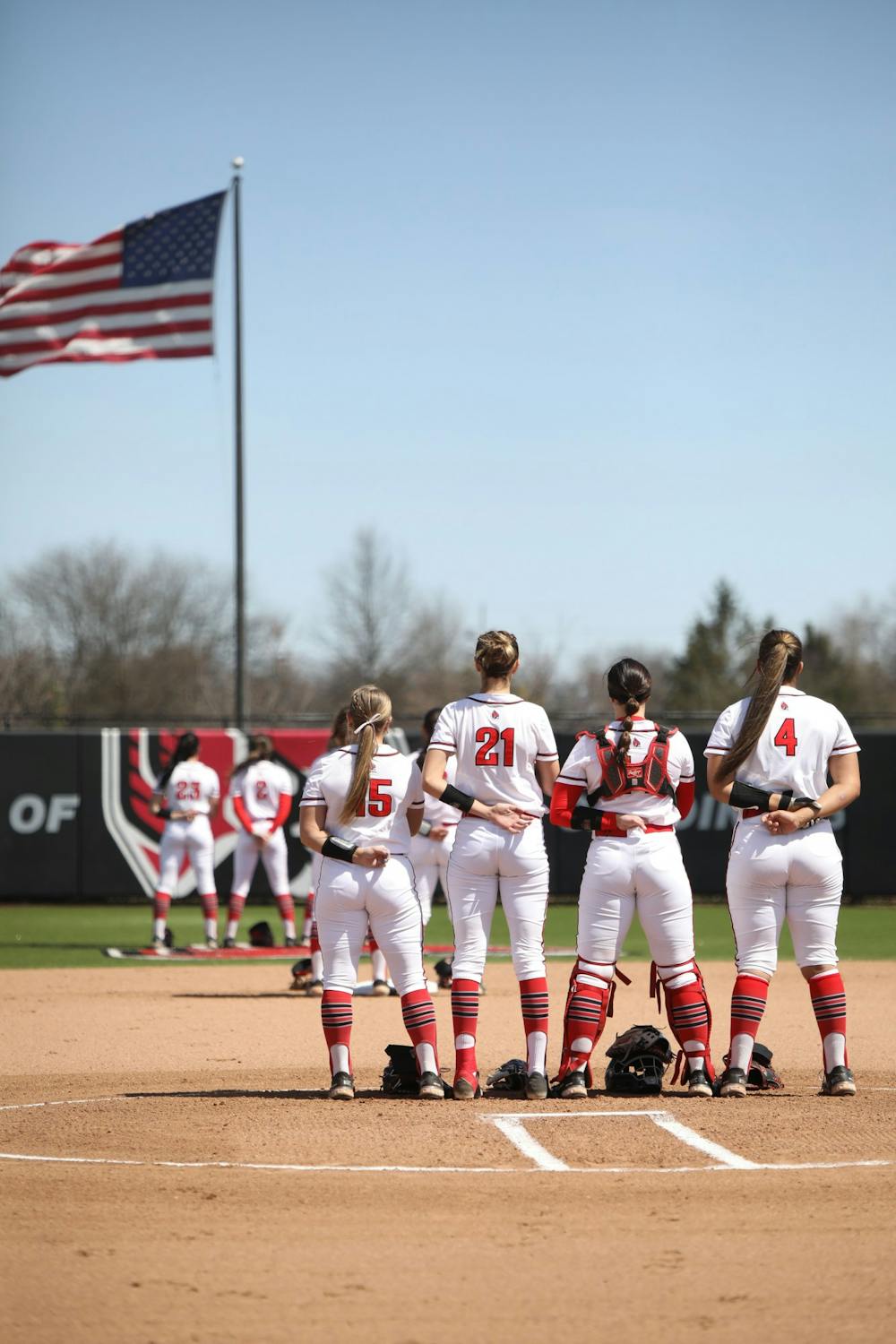 The Ball State Softball team stands on the field during the National Anthem before the game against Ohio April 10 at Varsity Softball Complex. The Cardinals lost 5-7. Amber Pietz, DN