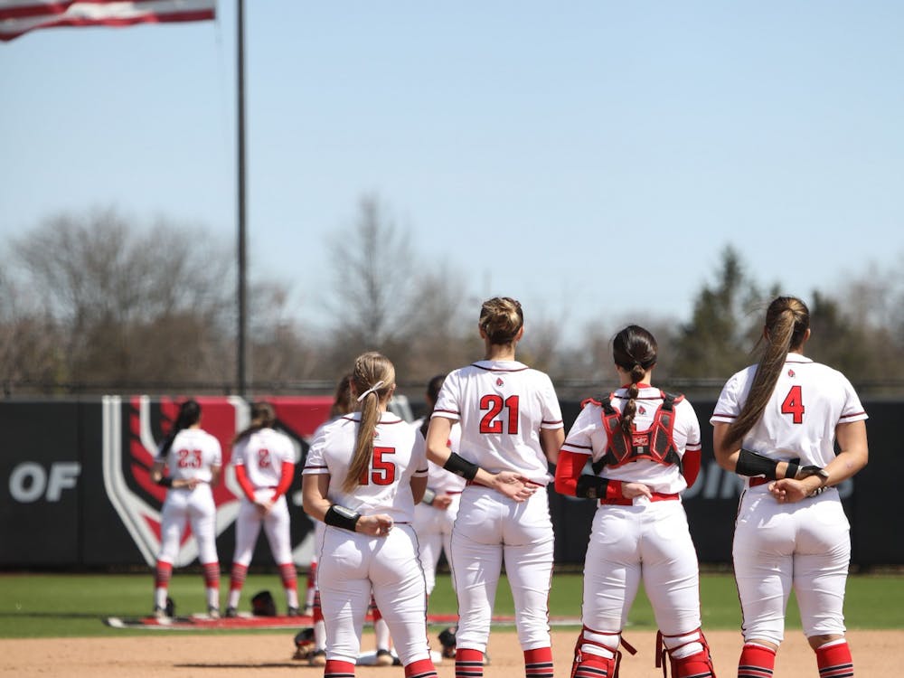 The Ball State Softball team stands on the field during the National Anthem before the game against Ohio April 10 at Varsity Softball Complex. The Cardinals lost 5-7. Amber Pietz, DN
