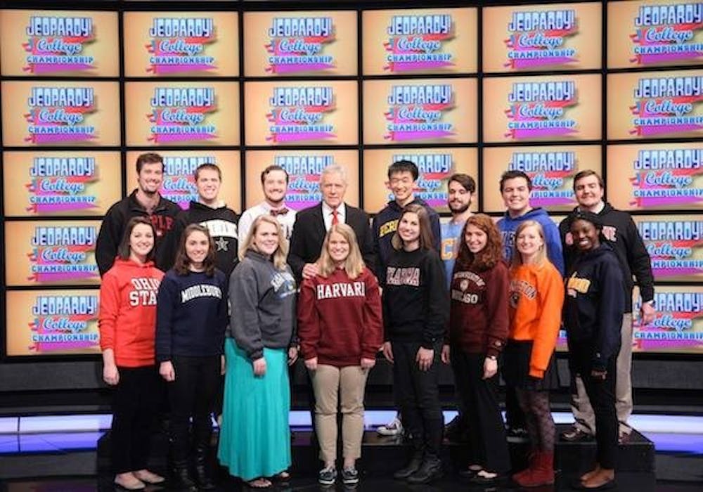 Senior marketing major Alex Sventeckis poses with 14 other contestants and Alex Trebek on the set of the 