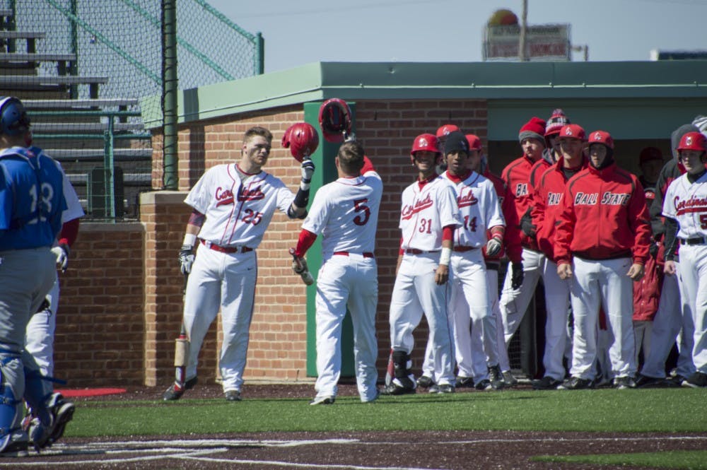 The Ball State baseball team congratulates junior infielder Ryan Spaulding after scoring a home run during the first game of the double header against Buffalo on March 28 at First Merchants Ballpark Complex. DN PHOTO ALAINA JAYE HALSEY