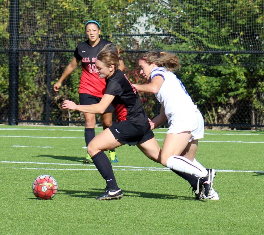 A Ball State soccer player attempts to keep the all away from her opponent in the match against Buffalo on Oct. 25 at the Briner Sports Complex. DN PHOTO ALLYE CLAYTON
