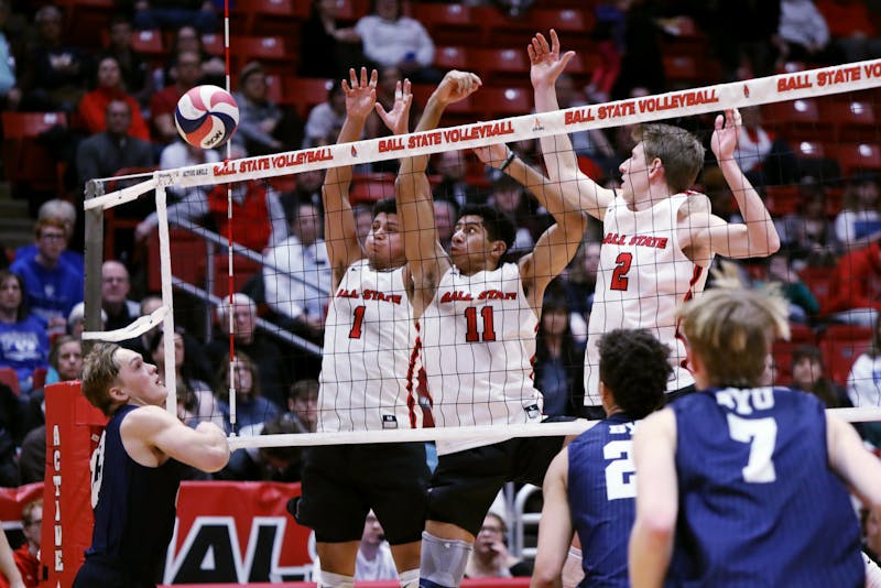 Fourth-year setter David Flores (left), graduate student middle blocker Felix Egharevba (center) and graduate student outside attacker Kaleb Jenness (right) go for a block in a game against BYU Feb. 2 at Worthen Arena. Ball State lost to BYU 3-1. Amber Pietz, DN