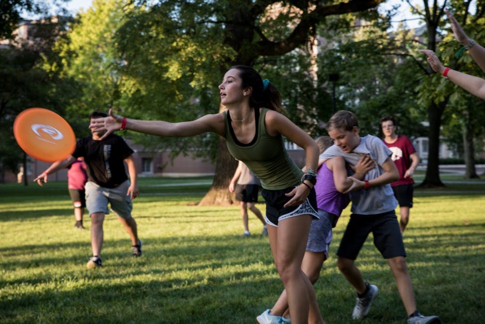 Locals play a game of pick-up ultimate Frisbee in the quad at Ball State University Aug, 23, 2019. Quad Bash is a community event for students and locals to hang out and make friends after the first week of classes at Ball State. Eric Pritchett, DN