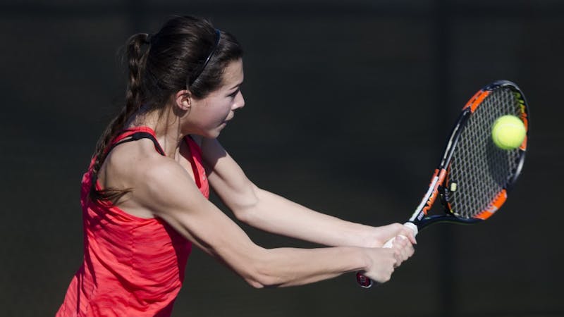 Sophomore Audrey Berger hits a backhand during her match against IUPUI on Feb. 19. Emma Rogers // DN