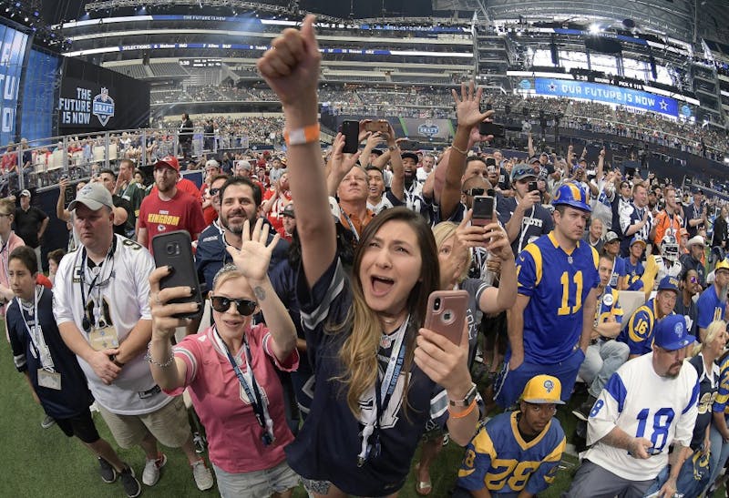 Dallas Cowboys fans celebrate as former Cowboys scout Gil Brandt announces Dorance Armstrong Jr., as the team's fourth-round pick during the final day of the 2018 NFL Draft at AT&T Stadium in Arlington, Texas, on Saturday, April 28, 2018. (Max Faulkner/Fort Worth Star-Telegram/TNS) 