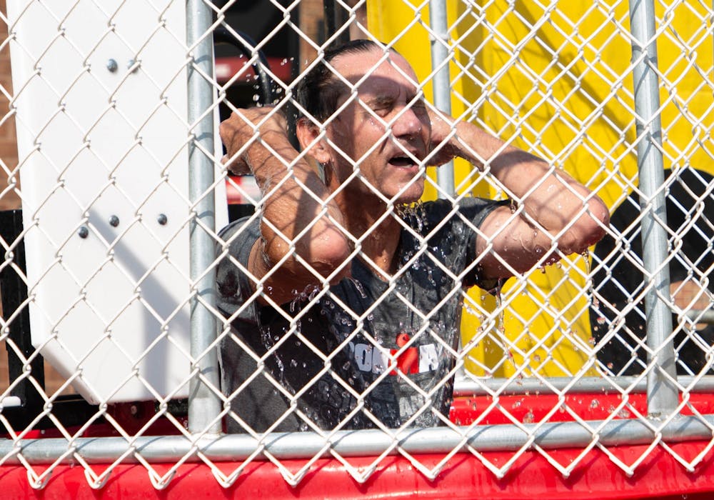 Muncie Mayor Dan Ridenour wipes water out of his eyes after falling into a dunk tank to raise money for charity in the Village, Aug. 28. Ridenour chose to raise money for local charities Heart of Indiana United Way and Home Savers of Delaware County. Adele Reich, DN