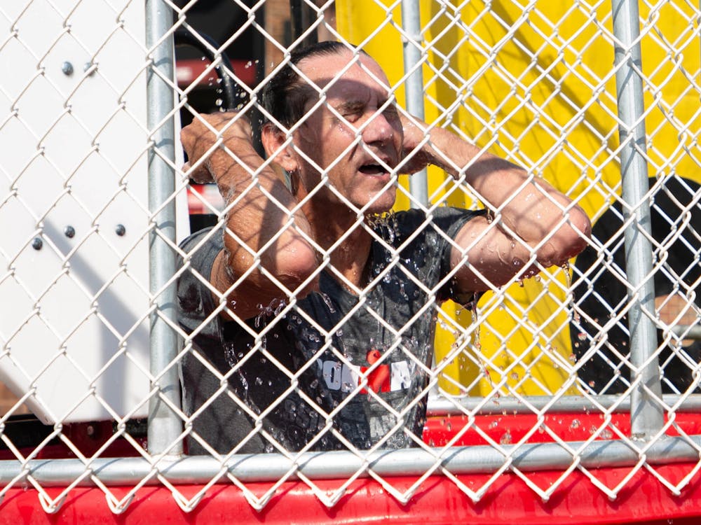 Muncie Mayor Dan Ridenour wipes water out of his eyes after falling into a dunk tank to raise money for charity in the Village, Aug. 28. Ridenour chose to raise money for local charities Heart of Indiana United Way and Home Savers of Delaware County. Adele Reich, DN