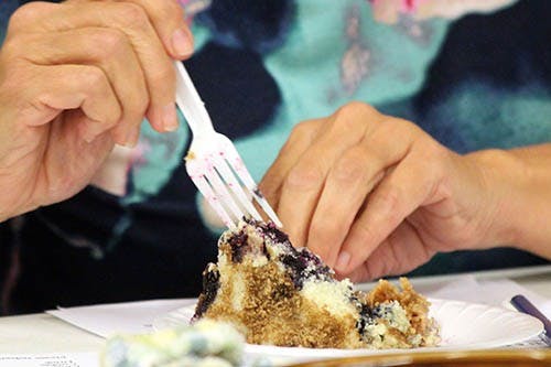 Brenda Nortrup, a microwave cooking judge, prepares to taste a blueberry coffee cake.  Kyley Kasey later won a red ribbon for her cake.  