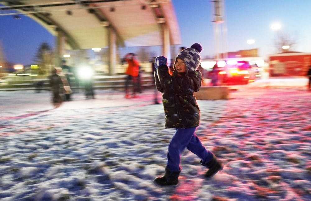 Lucas Feeney, 4, runs with a snowball during an event hosted by the Muncie Police Department (MPD) Jan. 27, 2019, at Canon Commons. The Muncie community received the chilly challenge at 6:30 that night. Scott Fleener, DN