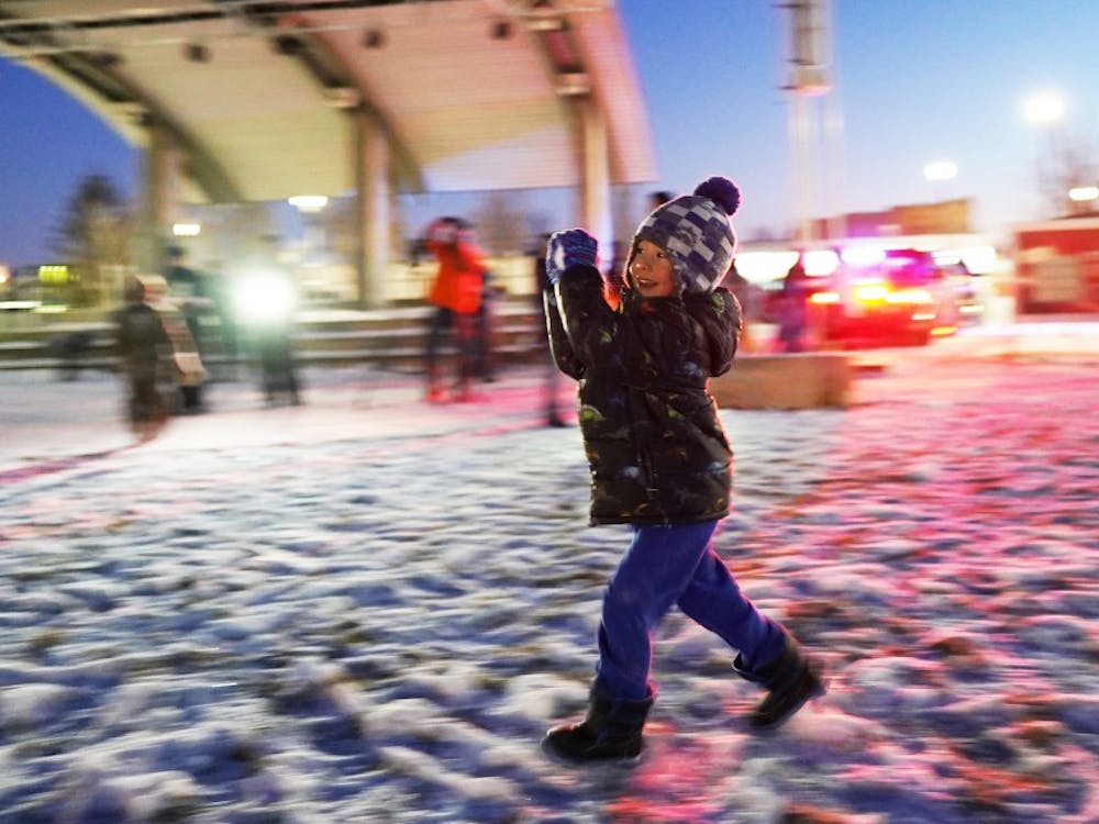 Lucas Feeney, 4, runs with a snowball during an event hosted by the Muncie Police Department (MPD) Jan. 27, 2019, at Canon Commons. The Muncie community received the chilly challenge at 6:30 that night. Scott Fleener, DN