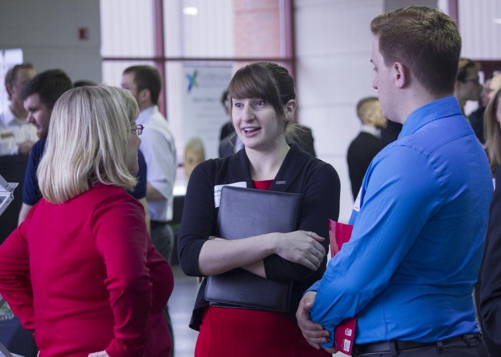 Students talk to a business representative during the Cardinal Job Fair on Feb. 11 at Worthen Arena. DN PHOTO JESSICA LYLE