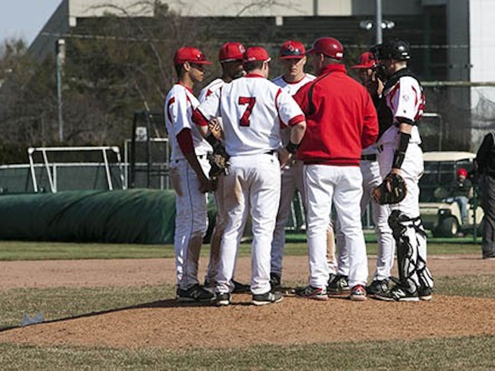 Members of the Baseball Team huddle together during the game against Northern Kentucky on Wednesday April 3. DN PHOTO JORDAN HUFFER