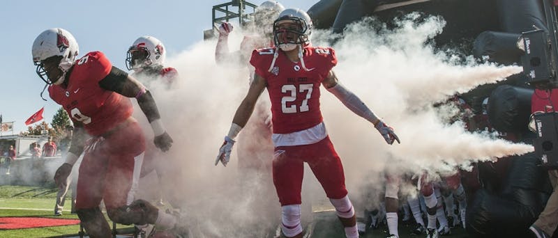 The team charges onto the field during the game against Akron on Oct. 25 at Scheumann Stadium. DN PHOTO JONATHAN MIKSANEK