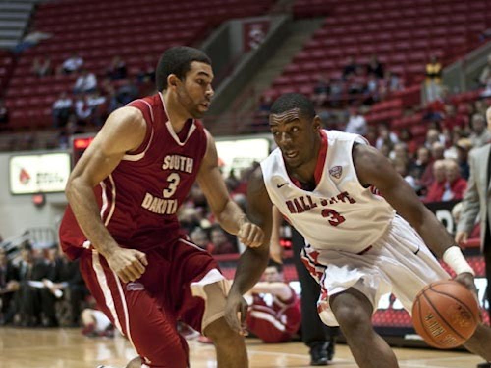 Freshman guard Marcus Posley attempts to drive past South Dakota's Steve Tecker during the game Dec. 8 in Worthen Arena. Posley came second on the team with 12 points. DN PHOTO JONATHAN MIKSANEK