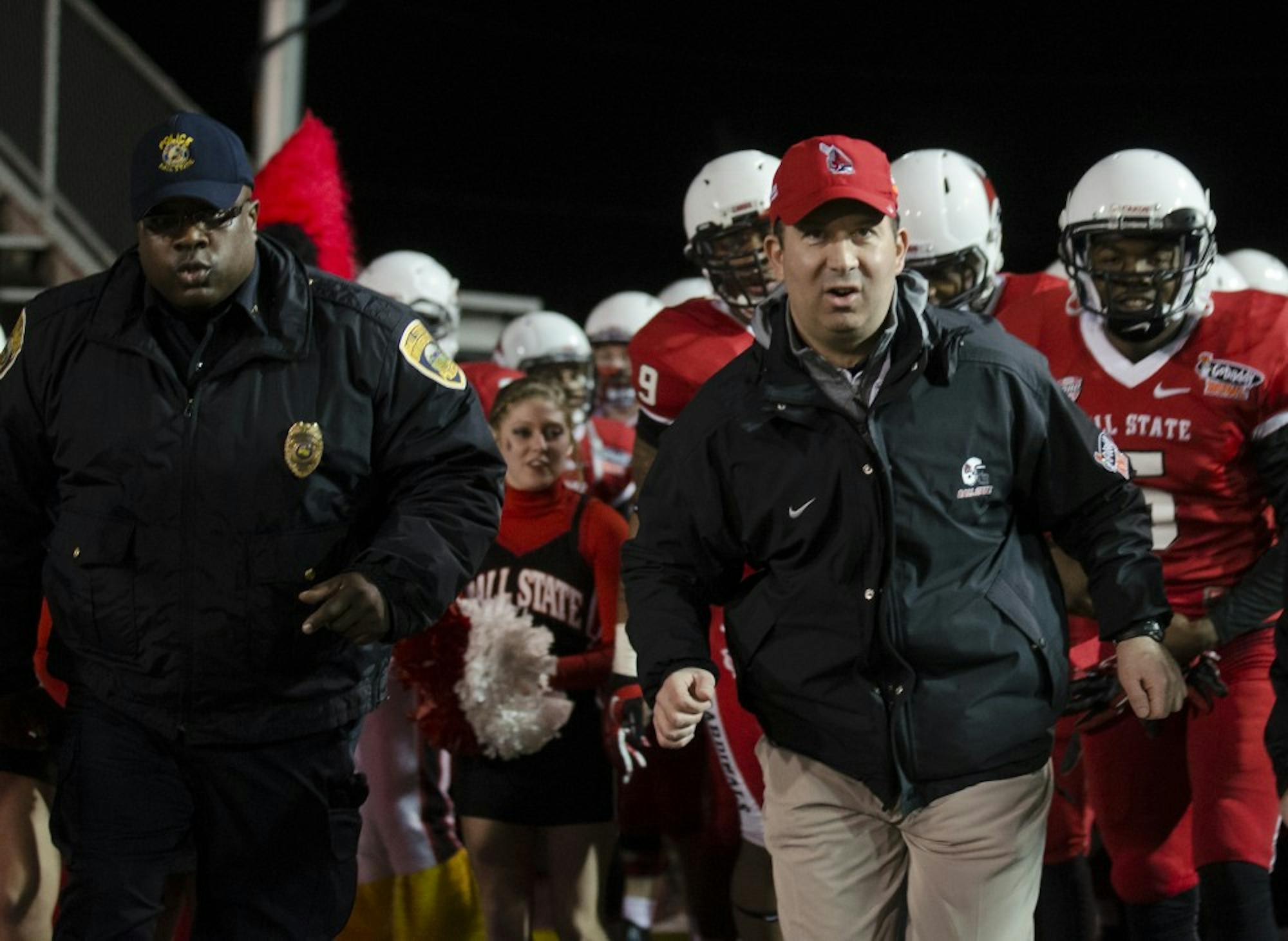 Head Coach Pete Lembo comes out of the gate with the team before kickoff at the Go Daddy Bowl Game in Mobile, Ala. on Jan 5. Ball State was tied with Arkansas State moving into the half with a score of 10 - 10. DN PHOTO COREY OHLENKAMP